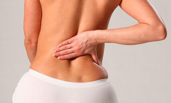 Back pain in the lumbar region of a woman.